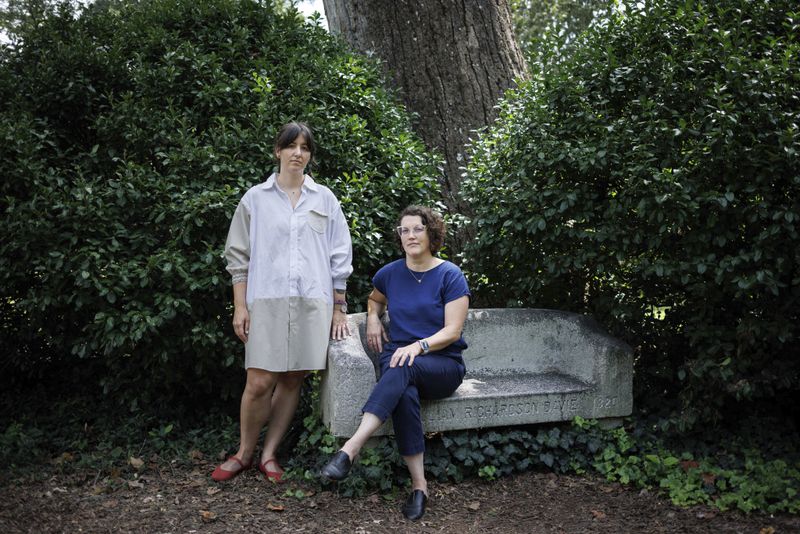 Professors Keely Muscatell, left, and Margaret Sheridan, right, pose together for a portrait on the campus of the University of North Carolina in Chapel Hill, N.C., Friday, Aug. 23, 2024. (AP Photo/Ben McKeown)