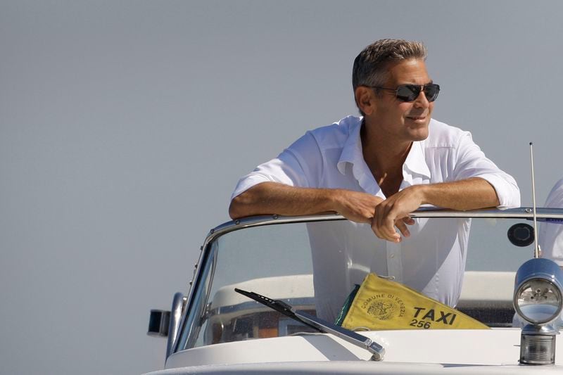 FILE - George Clooney arrives in Venice, Italy on a taxi boat for the 65th Venice Film Festival, Tuesday Aug. 26, 2008. (AP Photo/Joel Ryan, File)