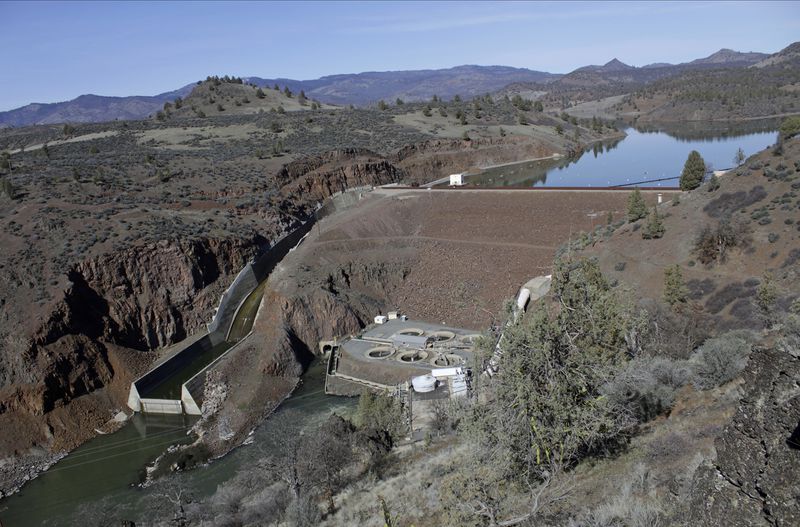 FILE - The Iron Gate Dam powerhouse and spillway are seen on the lower Klamath River near Hornbrook, Calif., on March 2, 2020. (AP Photo/Gillian Flaccus, File)