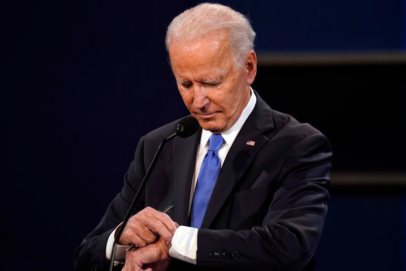 FILE - Democratic presidential candidate former Vice President Joe Biden checks his watch during the second and final presidential debate Oct. 22, 2020, at Belmont University in Nashville, Tenn., with President Donald Trump. (AP Photo/Patrick Semansky, File)