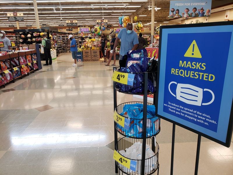 Kroger has installed signs at its stores in metro Atlanta, urging customers to wear masks. Meanwhile, some communities around Georgia have begun mandating mask use by the general public in some cases. MATT KEMPNER / AJC