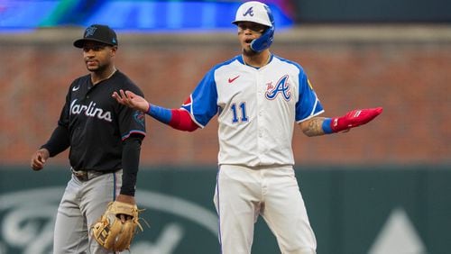 Atlanta Braves Orlando Arcia (11) reacts after a base hit by Atlanta Braves Matt Olson in the third inning of a baseball game against the Miami Marlins, Saturday, Aug. 3, 2024, in Atlanta. (AP Photo/Jason Allen)