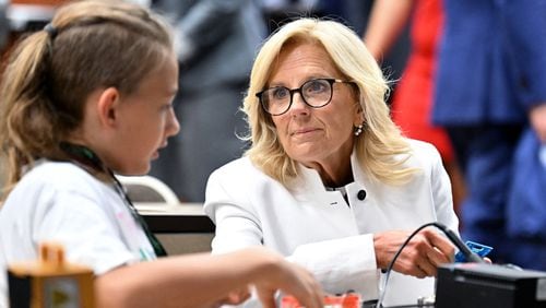 First Lady Jill Biden experiences soldering as one of students helps as she and other officials visit Cougar Manufacturing Camp, where students age 12-14 learn about virtual reality and STEM activities, during America Workforce Hub tour at Augusta Technical College, Tuesday, July 18, 2023, in Augusta, Georgia. First Lady Jill Biden and U.S. Secretary of Education Miguel Cardona meet with local officials and key stakeholders leading the Investing in America Workforce Hub in Augusta, Georgia to highlight to how Bidenomics is delivering investments and jobs to communities across the country. (Hyosub Shin / Hyosub.Shin@ajc.com)