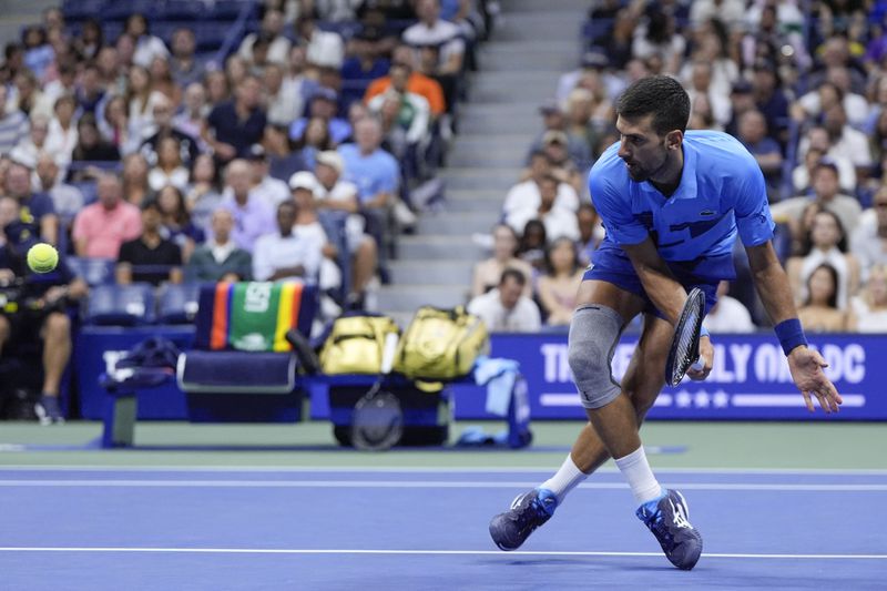 Novak Djokovic, of Serbia, returns a shot to Alexei Popyrin, of Australia, during a third round match of the U.S. Open tennis championships, Friday, Aug. 30, 2024, in New York. (AP Photo/Julia Nikhinson)