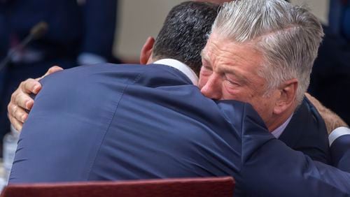 FILE - Actor Alec Baldwin, right, hugs his defense attorney Alex Spiro after District Court Judge Mary Marlowe Sommer threw out the involuntary manslaughter case, July 12, 2024, in Santa Fe, N.M., for the 2021 fatal shooting of cinematographer Halyna Hutchins during filming of the Western movie "Rust." (Luis Sánchez Saturno/Santa Fe New Mexican via AP, Pool, File)