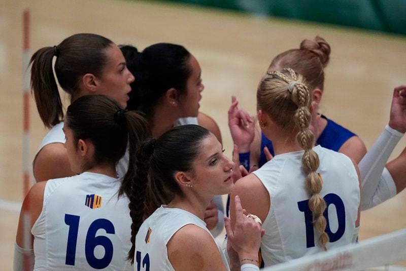 San Jose State middle blocker Emma Testi, front, enters a huddle with teammates in the first set of an NCAA college volleyball match against Colorado State, Thursday, Oct. 3, 2024, in Fort Collins, Colo. (AP Photo/David Zalubowski)