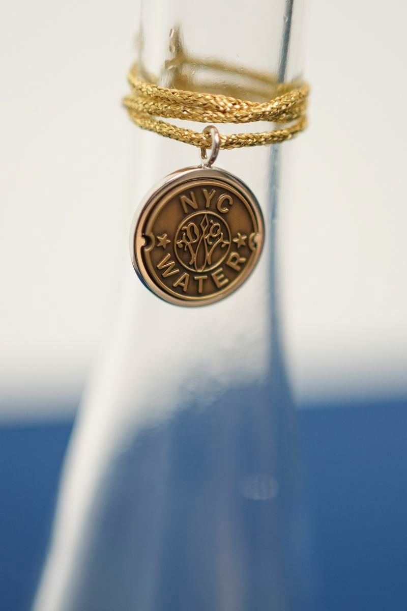 A bottle containing NYC tap water is displayed at a news conference about repairs occurring to the water supply infrastructure in New York, Monday, Sept. 30, 2024. (AP Photo/Seth Wenig)