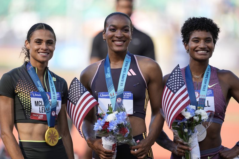 First place winner Sydney McLaughlin-Levrone, left, second place Anna Cockrell, right, and third place Jasmine Jones pose fopr a photo after the women's 400-meter hurdles final during the U.S. Track and Field Olympic Team Trials, Sunday, June 30, 2024, in Eugene, Ore.(AP Photo/Charlie Neibergall)