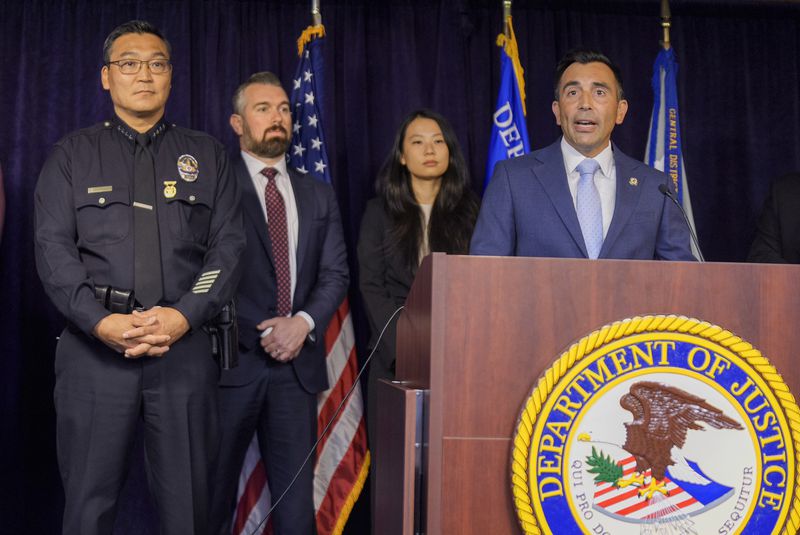 United States Attorney Martin Estrada, at podium, is joined by Los Angeles Police Chief Dominic Choi, far left, and other officials to announce court filings related to the death of actor Matthew Perry in Los Angeles on Thursday, Aug. 15, 2024. (AP Photo/Damian Dovarganes)