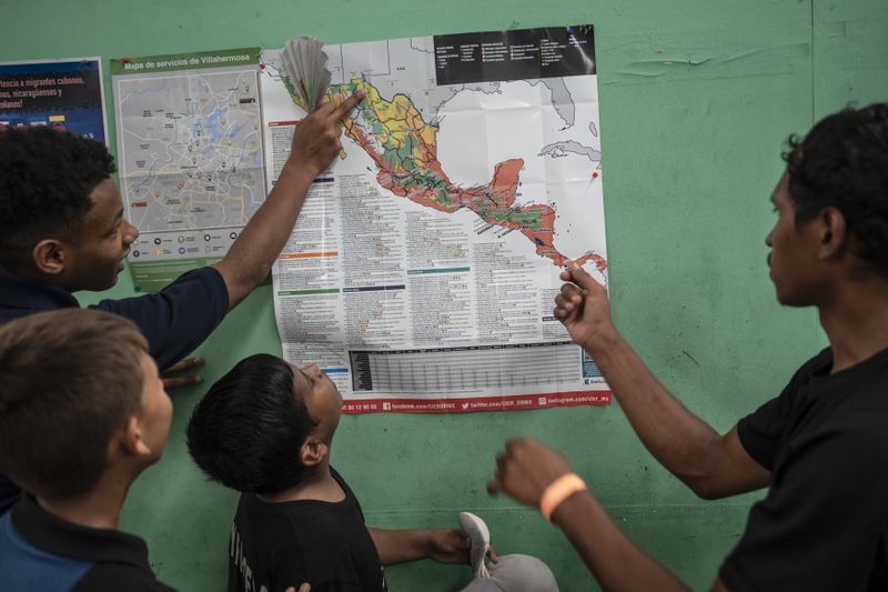 Teenager migrants look at a map of Mexico at the Peace Oasis of the Holy Spirit Amparito shelter in Villahermosa, Mexico, on Friday, June 7, 2024. After the head of Mexico's immigration agency ordered a halt to deportations in December, migrants have been left in limbo as authorities round up migrants across the country and dump them in the southern Mexican cities of Villahermosa and Tapachula. (AP Photo/Felix Marquez)