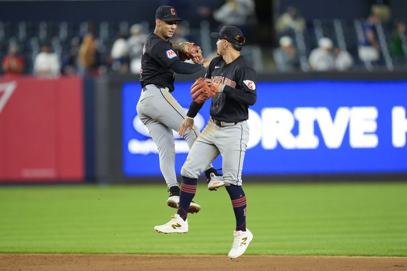 Cleveland Guardians' Brayan Rocchio, left, and Andrés Giménez celebrate after a baseball game against the New York Yankees at Yankee Stadium Tuesday, Aug. 20, 2024, in New York. The Guardians defeated the Yankees in extra innings 9-5.(AP Photo/Seth Wenig)