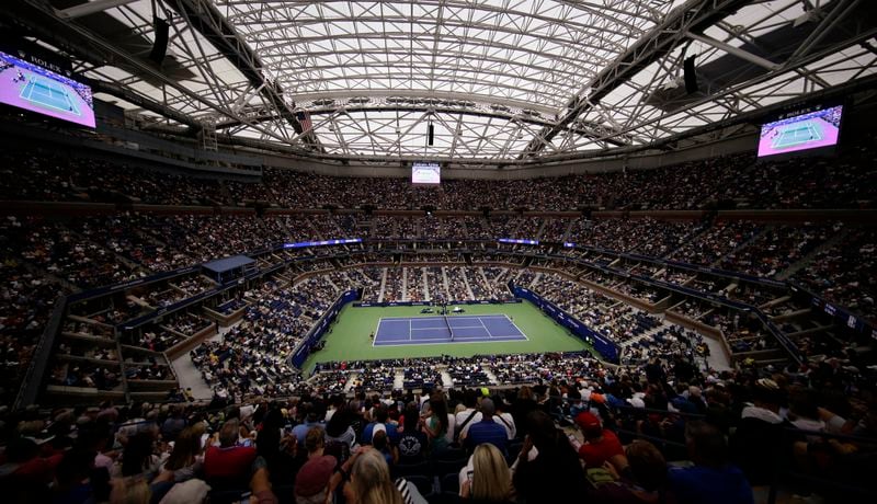 FILE - With rain falling outside, Naomi Osaka, of Japan, and Belinda Bencic, of Switzerland, play their match under the roof of Arthur Ashe Stadium during the fourth round of the U.S. Open tennis championships, Monday, Sept. 2, 2019, in New York. (AP Photo/Frank Franklin II, File)