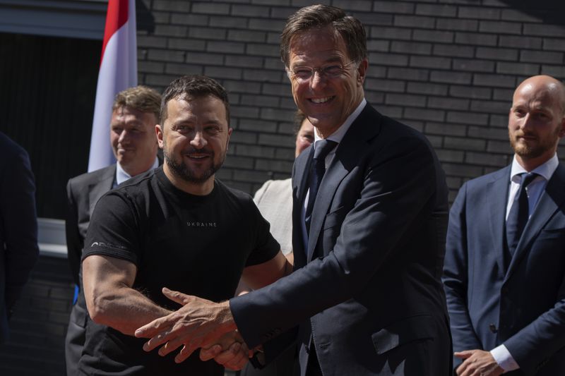 FILE - Ukrainian President Volodymyr Zelenskyy, left, is greeted by Dutch caretaker Prime Minister Mark Rutte in Eindhoven, Netherlands, Sunday, Aug. 20, 2023. Over the course of more than a dozen years at the top of Dutch politics, Mark Rutte got to know a thing or two about finding consensus among fractious coalition partners. Now he's going to bring the experience of leading four Dutch multiparty governments to the international stage as NATO's new secretary general. (AP Photo/Peter Dejong, File)