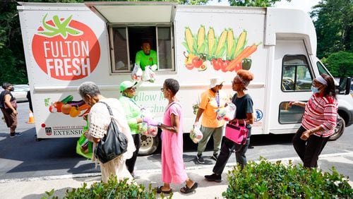 With the Fulton Fresh Mobile Market truck, Queante Jennings and Shirley Dodd (center) hand out free produce bags to St Mark AME Church nutrition class attendees on Tuesday, June 18, 2024. The area is considered a “food desert” because there are no grocery stores.
(Miguel Martinez / AJC)