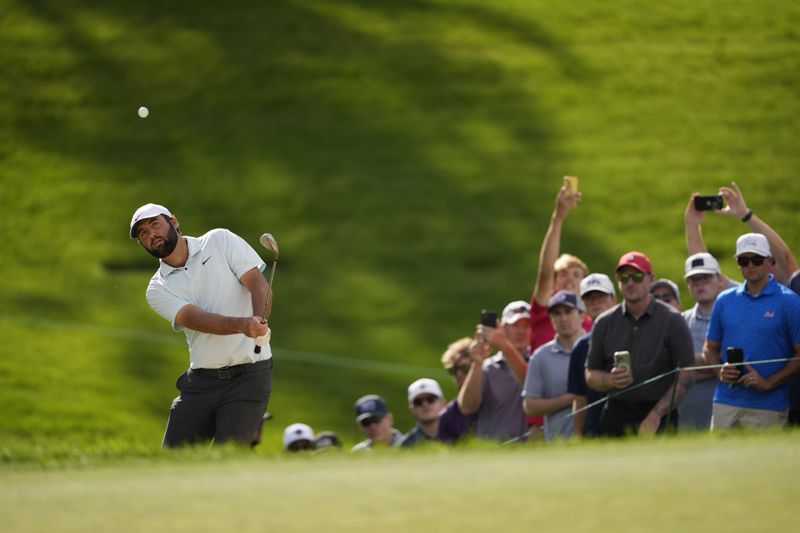 Scottie Scheffler chips onto the first green during the third round of the BMW Championship golf event at Castle Pines Golf Club, Saturday, Aug. 24, 2024, in Castle Rock, Colo. (AP Photo/Matt York)