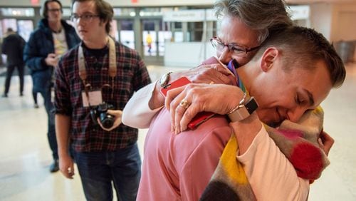 JJ Warren of New York embraces Julie Arms Meeks of Atlanta during protests outside the United Methodist Church's 2019 Special Session of the General Conference in St. Louis, Mo., Tuesday, Feb. 26, 2019. The United Methodist Church faces a likely surge in defections and defiance after delegates at a crucial conference voted to uphold — and bolster — the denomination’s stance against homosexuality, same-sex marriage and the ordination of openly gay clergy. (AP Photo/Sid Hastings)