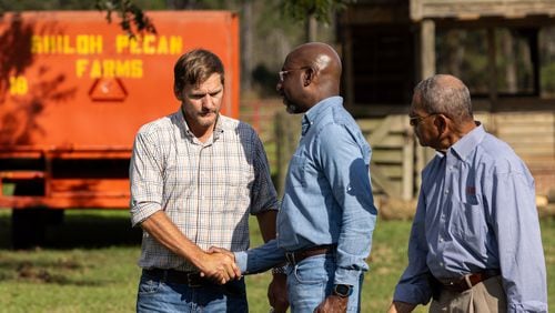 U.S. Sen. Raphael Warnock, D-Ga., greets pecan farmer Buck Paulk at the farmer’s property in Ray City on Thursday, October 3, 2024, as President Joe Biden and others survey damage from Hurricane Helen. (Arvin Temkar / AJC)
