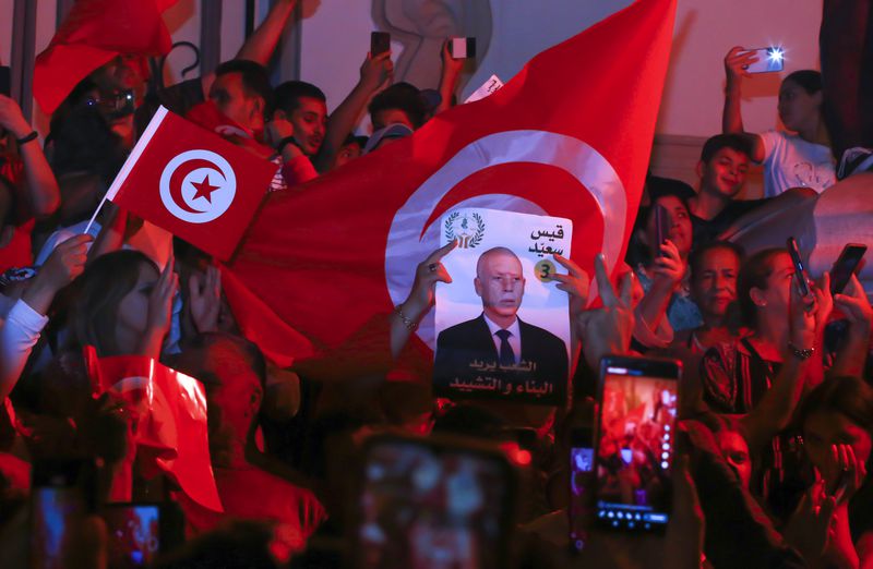 Supporters of Tunisian president and candidate for re-election Kais Saied celebrate after the announcement of the provisional results for the presidential elections, in the capital Tunis, Tunisia, Sunday, Oct. 6, 2024. (AP Photo/Anis Mili)