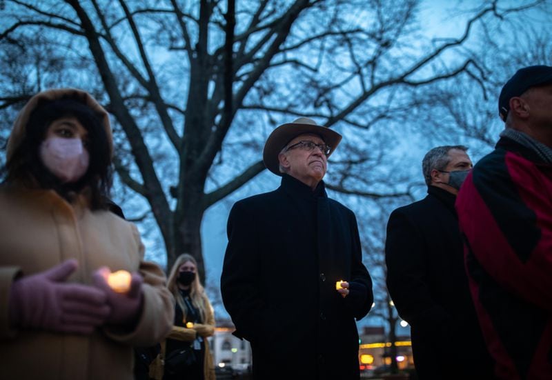 Former District Attorney Tom Charron (center) was one of dozens who attended a vigil to commemorate the deaths of four people killed 30 years ago in Cobb County.