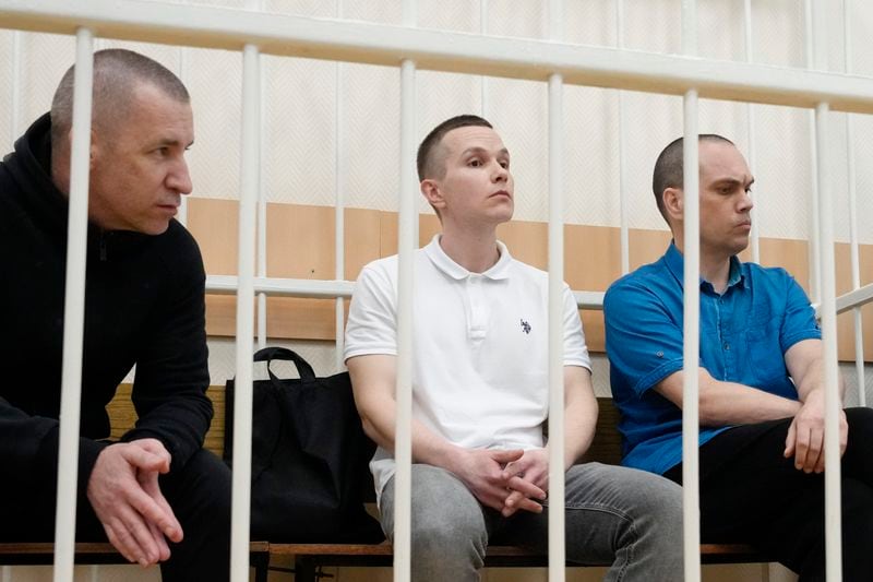 Former Navalny's lawyers Igor Sergunin, from left, Alexei Liptser and Vadim Kobzev sit in the cage during a court session in Petushki, Vladimir region, about 120 kilometers (75 miles) east of Moscow, Russia, Thursday, Sept. 12, 2024. (AP Photo/Alexander Zemlianichenko)