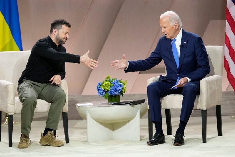 President Joe Biden, right, reaches to shake the hand of Ukraine's President Volodymyr Zelenskyy during a meeting on the sidelines of the NATO Summit in Washington, Thursday, July 11, 2024. (AP Photo/Susan Walsh)