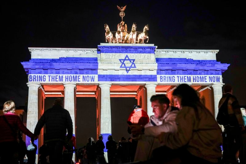 The Brandenburg Gate is illuminated with the flag of Israel in Berlin, Germany, Monday, Oct. 7, 2024, to mark the anniversary of the Hamas attack on Israel on Oct. 7, 2023. (Kay Nietfeld/dpa via AP)