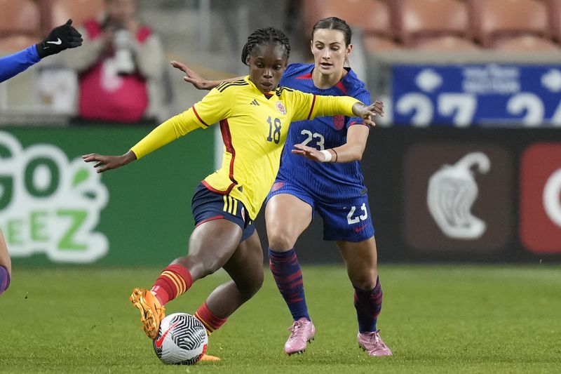 FILE - United States' Emily Fox (23) defends against Colombia forward Linda Caicedo (18) during the first half of an international friendly soccer match Thursday, Oct. 26, 2023, in Sandy, Utah. The 19-year-old Colombian is readying to play at the Olympics in France and maybe — although it's a stretch — the under-20 Women’s World Cup hosted by her home country starting in late August. (AP Photo/Rick Bowmer, File)