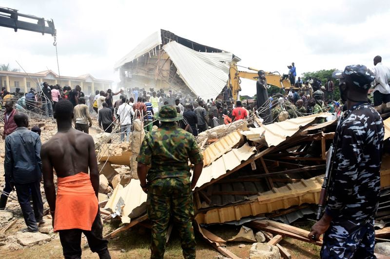 People gather at the scene of a collapsed two-storey building in Jos, Nigeria, Friday, July, 12, 2024. At least 12 students have been killed after a school building collapsed and trapped them in northern Nigeria, authorities said on Friday. (AP Photos)