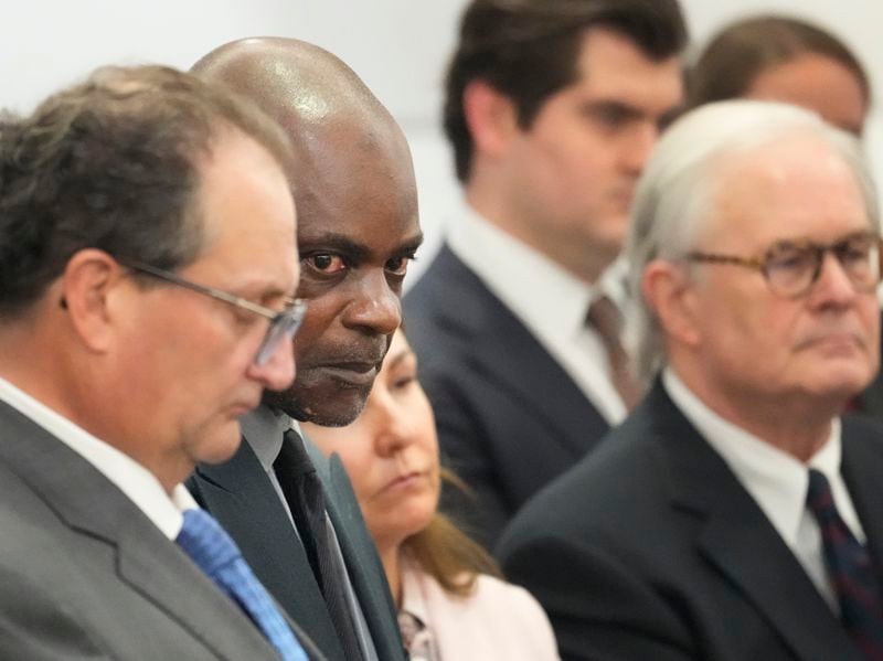 Former Houston police officer Gerald Goines, second from left, stands with his defense attorneys Reagan Wynn, left, Nicole DeBorde Hochglaube, center, and Mac Secrest, right, at the Harris County Criminal courthouse after he was found guilty Wednesday, Sept. 25, 2024, in Houston. (Melissa Phillip/Houston Chronicle via AP)