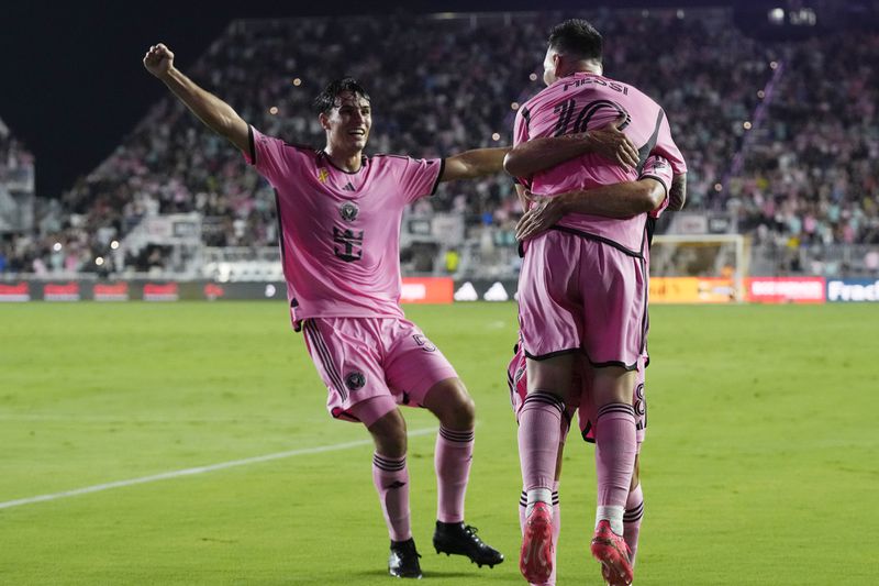 Inter Miami forward Lionel Messi (10) its hugged by his teammates after scoring his second goal during the first half of an MLS soccer match against the Philadelphia Union, Saturday, Sept. 14, 2024, in Fort Lauderdale, Fla. (AP Photo/Marta Lavandier)