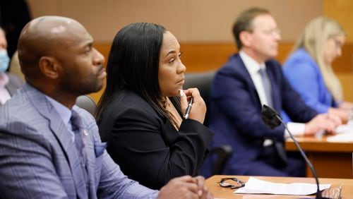 Lawyers from Fulton County D.A. office and layers representing news organizations listen to Fulton County Superior Court Judge Robert McBurney during a hearing about a petition submitted by news organizations during a Jan. 24, 2023, hearing over whether to release the final report of a special grand jury.Miguel Martinez / miguel.martinezjimenez@ajc.com