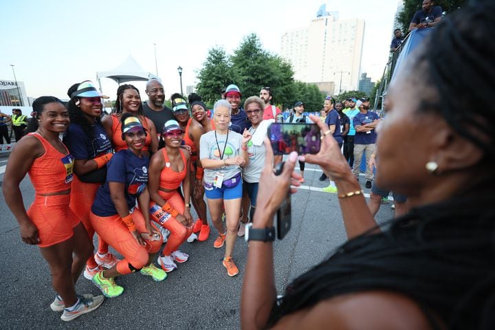 Runners pose for photo at the start of the 55th running of the Atlanta Journal-Constitution Peachtree Road Race in Atlanta on Thursday, July 4, 2024.   (Miguel Martinez / AJC)