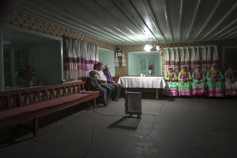 Yuri Strukov, second left, and his son Ilya, left, pray at the former Orphanage house where Doukhobors has worshiped for years, on Easter in the remote mountain village of Gorelovka, Georgia, Saturday, May 4, 2024. (AP Photo/Kostya Manenkov)