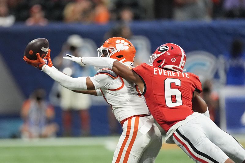 Clemson wide receiver Antonio Williams (0) makes a catch as Georgia defensive back Daylen Everette (6) defends during the first half of an NCAA college football game Aug. 31, 2024, in Atlanta. (AP Photo/John Bazemore)