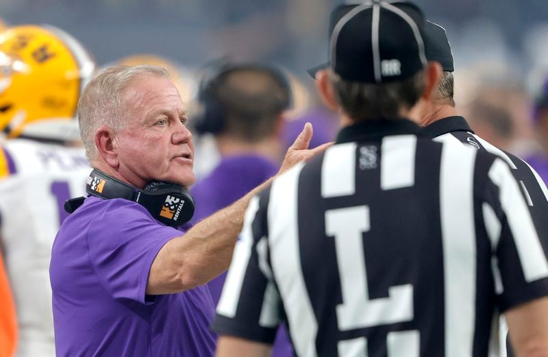 LSU head coach Brian Kelly, left, talks with officials during the first half of an NCAA college football game against Southern California, Sunday, Sept. 1, 2024, in Las Vegas. (AP Photo/Steve Marcus)