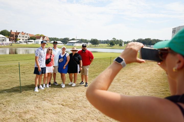 The Flores family from McDonough gets a photo with the East Lake Gold Club clubhouse in the background on the last day of the Tour Championship at East Lake Golf Club, Sunday, Sept. 1, 2024, in Atlanta.
(Miguel Martinez / AJC)