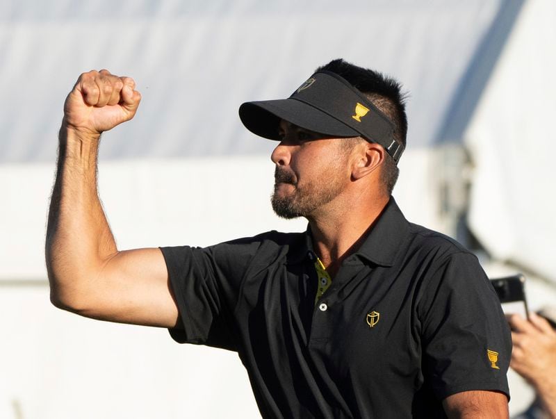 International team member Jason Day of Australia, celebrates after defeating the United States team on the eighteenth hole of their second round foursome match at the Presidents Cup golf tournament at the Royal Montreal Golf Club, in Montreal, Friday, Sept. 27, 2024. (Christinne Muschi/The Canadian Press via AP)