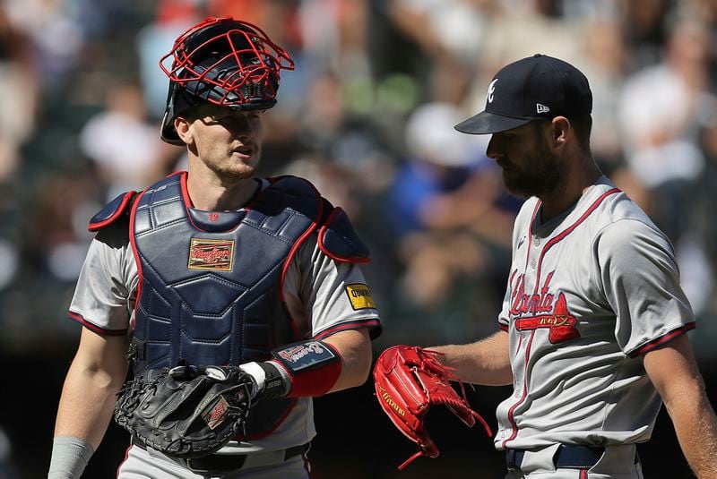 Atlanta Braves' Sean Murphy, left, chats with Chris Sale as they walk back to the dugout at the end of the third inning of a baseball game against the Chicago White Sox, Thursday, June 27, 2024, in Chicago. (AP Photo/Melissa Tamez)