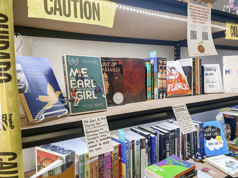 Various challenged books, including "Me and Earl and the Dying Girl" by Jesse Andrews, second left, are displayed at the White Rose Books & More bookstore in Kissimmee, Fla. on Wednesday, May 22, 2024. (Erin Decker/White Rose Books & More via AP)