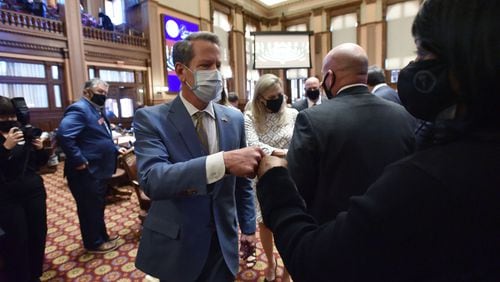 January 14, 2021 Atlanta - Gov. Brian Kemp exchanges fist-bumps with lawmakers as he leaves after he delivered the State of the State Address to lawmakers in the House Chambers during the 4th day of the 2021 legislative session at the Georgia State Capitol building on Thursday, January 14, 2021. (Hyosub Shin / Hyosub.Shin@ajc.com)