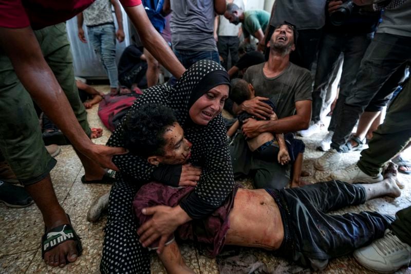 Palestinians mourn their relatives killed in the Israeli bombardment of the Gaza Strip at a hospital morgue in Deir al-Balah, Wednesday, Aug. 28, 2024. (AP Photo/Abdel Kareem Hana)