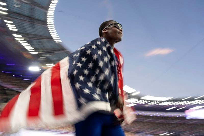 The United States' Christopher Bailey, takes a victory lap after his team won the men's 4 x 400 meters relay final at the 2024 Summer Olympics, Saturday, Aug. 10, 2024, in Saint-Denis, France. (AP Photo/David Goldman)