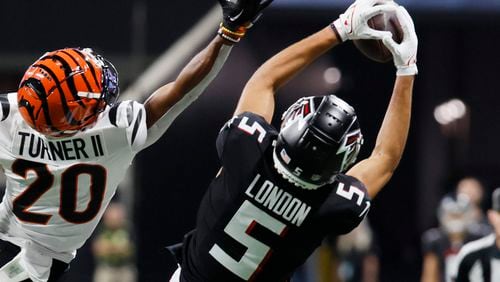 Falcons wide receiver Drake London (5) catches the ball against Bengals cornerback DJ Turner II (20) during the first half in an exhibition game against the Cincinnati Bengals at Mercedes-Benz Stadium on Friday, August 18, 2023, in Atlanta. (Miguel Martinez/miguel.martinezjimenez@ajc.com)