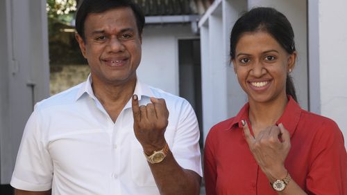 Sri Lankan show their index fingers marked with an indelible ink after casting their vote at a polling center for presidential election in Colombo, Sri Lanka, Saturday, Sept. 21, 2024. (AP Photo/Rajesh Kumar Singh)