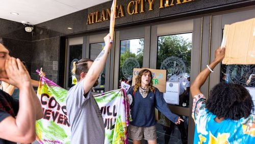Protesters confront police at Atlanta City Hall ahead of the final vote to approve legislation to fund the public safety training center on Monday, June 5, 2023. (Arvin Temkar / arvin.temkar@ajc.com)