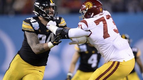 Iowa defensive end A.J. Epenesa, left, is blocked by Southern California offensive tackle Austin Jackson (73) during the first half of the Holiday Bowl NCAA college football game Friday, Dec. 27, 2019, in San Diego. (AP Photo/Orlando Ramirez)