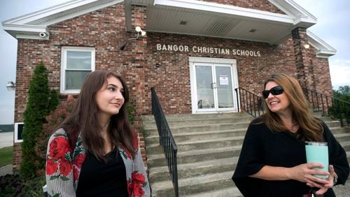 FILE - Olivia Carson, then a 15-year-old sophomore, of Glenburn, Maine, left, stands with her mother Amy outside the Crosspoint Church-affiliated Bangor Christian Schools on August 28, 2018 in Bangor, Maine. (Gabor Degre/The Bangor Daily News via AP, File)