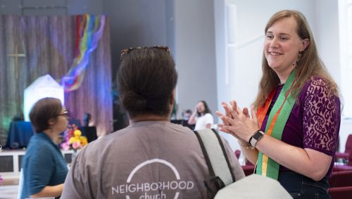 The Rev. Andi Woodworth speaks with a church member before service at Neighborhood Church in Candler Park on Sunday, June 30, 2024.  (Ben Gray / Ben@BenGray.com)