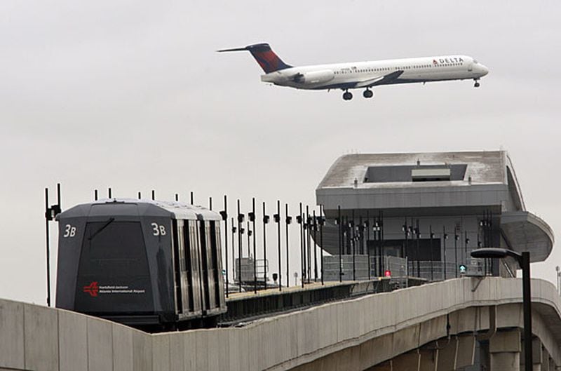An ATL SkyTrain moves down the rail near the Georgia International Convention Center Gateway station.