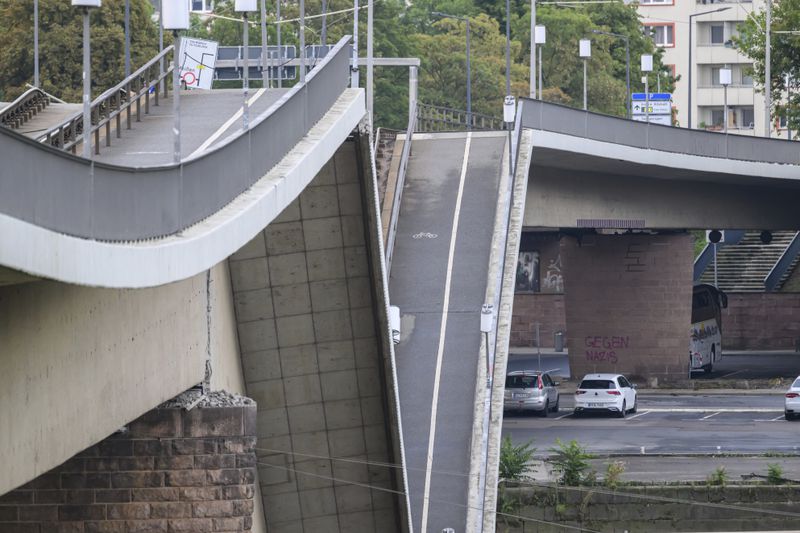 Parts of the Carola Bridge over the Elbe is seen collapsed in Dresden, eastern Germany, Wednesday, Sept. 11, 2024. (Robert Michael/dpa via AP)